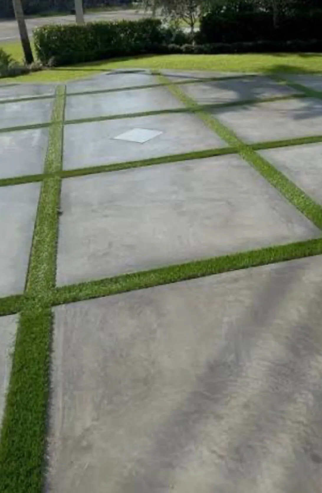 Smooth-finished concrete pads separated by strips of turf